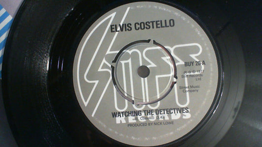 Elvis Costello : Watching The Detectives (7", Single, dar)