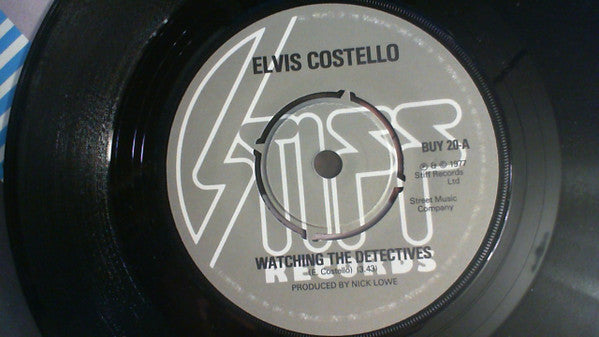 Elvis Costello : Watching The Detectives (7", Single, dar)